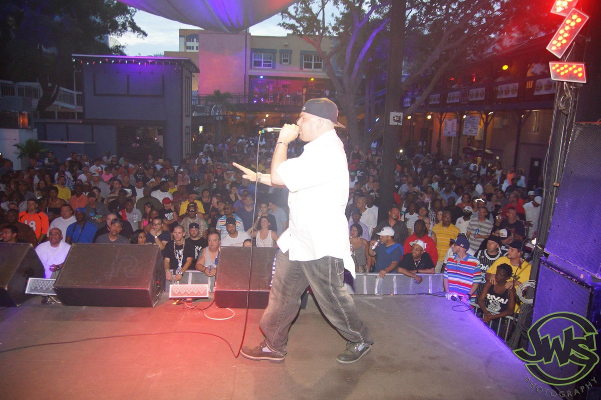 Eric Gomez performing on stage to a full crowd